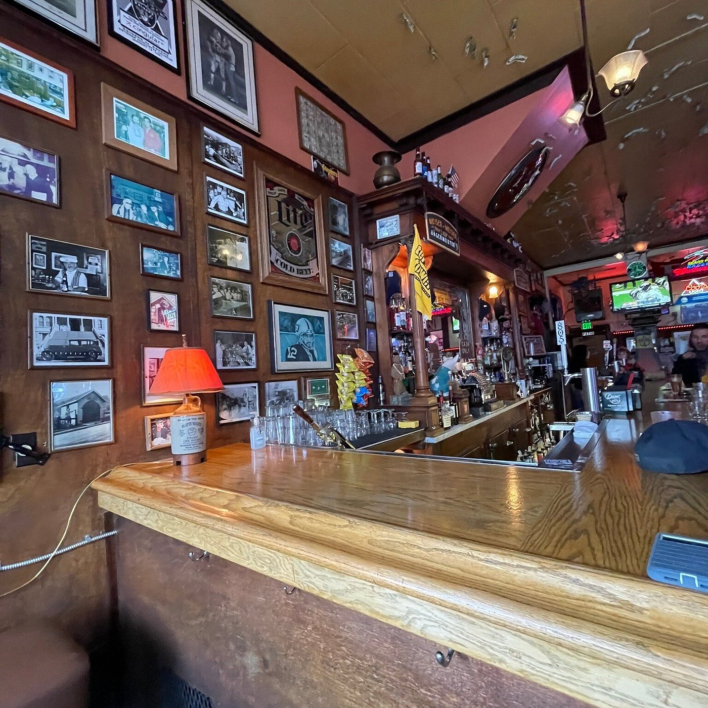The bar counter and a wall of framed photos