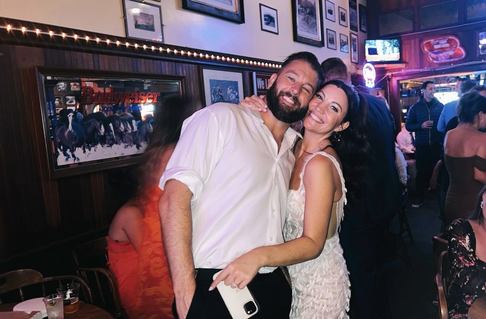 A crowd at the bar under the neon