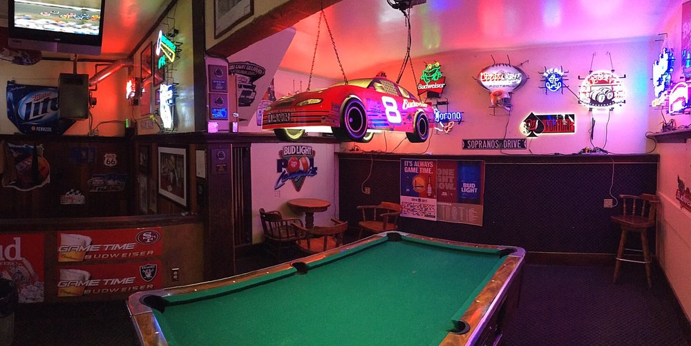 The pool table under neon signs