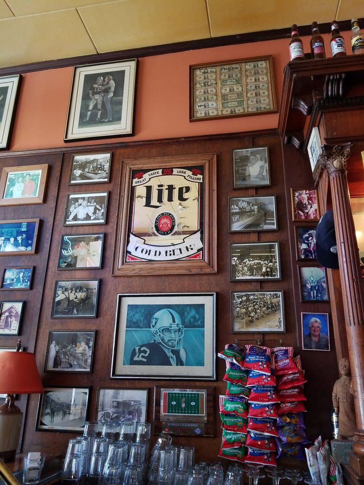 Walls covered in framed photos, memorabilia and neon at Nave's